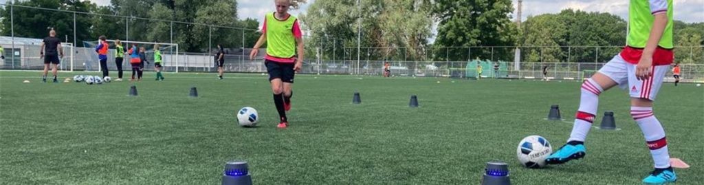 Young female football players training with SportBrain's SMARTGOALS at MVVA academy.